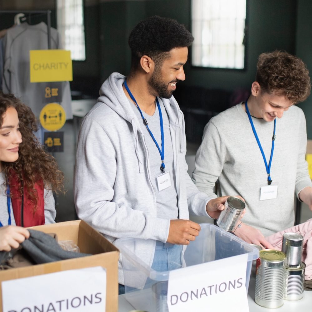 A group of volunteers working in community charity donation center.
